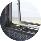 Open gray crank awning window in Holland Michigan house