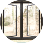 Open dark colored casement windows in Michigan home