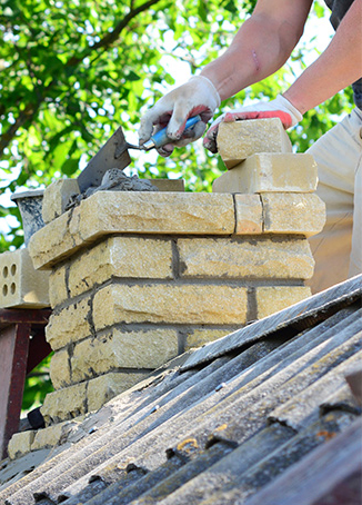 Masonry contractor building chimney in Grand Rapids
