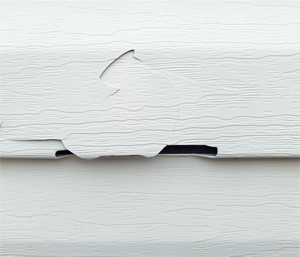 Siding damaged by an ice dam